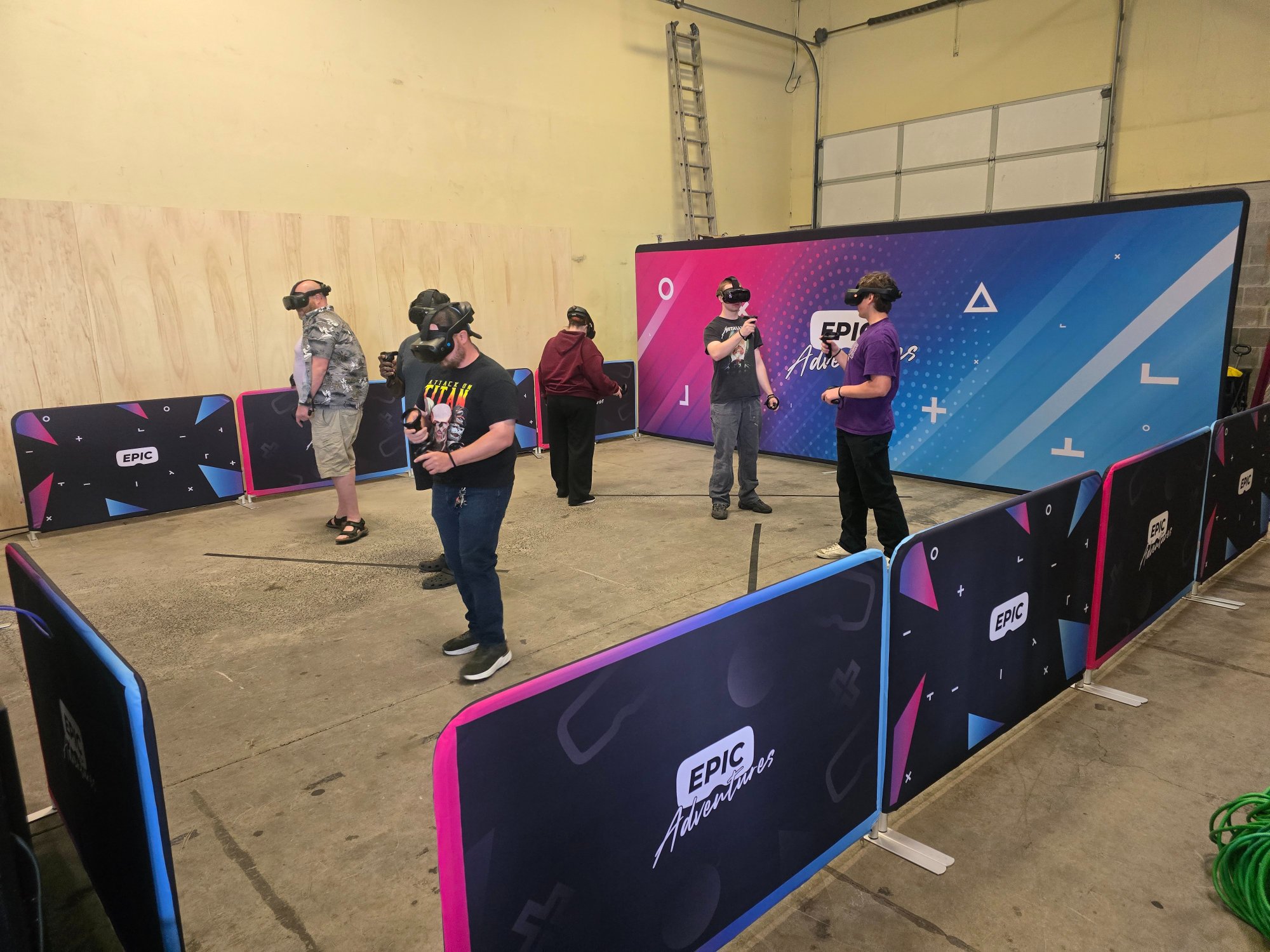 Epic Adventures mobile VR arena set up at Bounce-n-Battle in Vancouver WA with branded barriers and 5 players in VR headsets